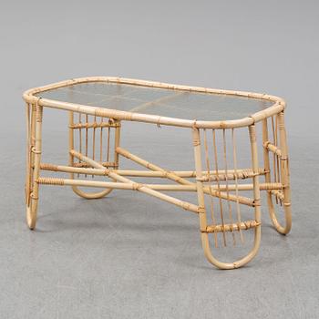 A rattan and glass table and a rattan sofa, second half of the 20th century.