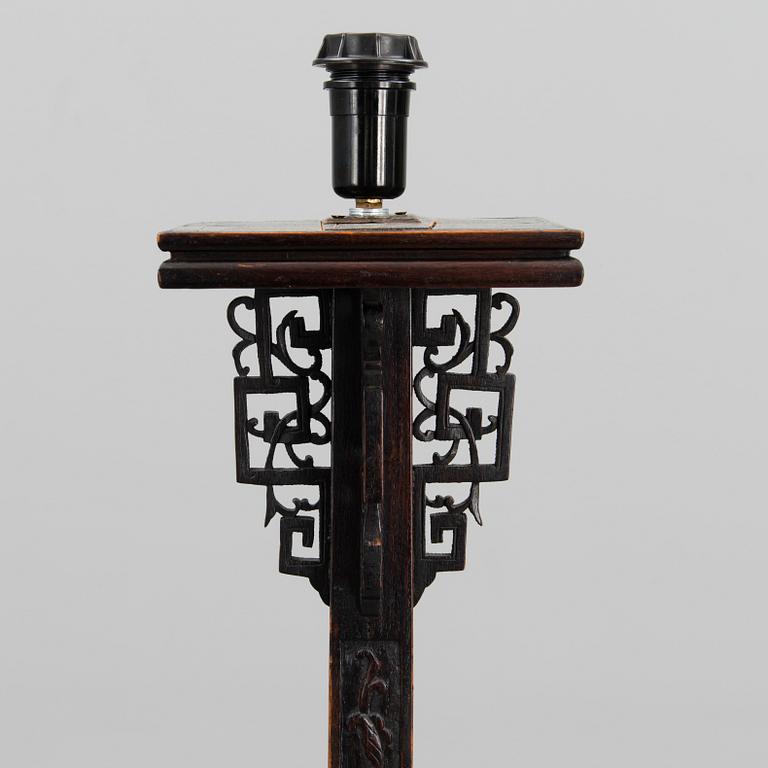 A Chinese carved wood floor lamp from the first half of the 20th Century.