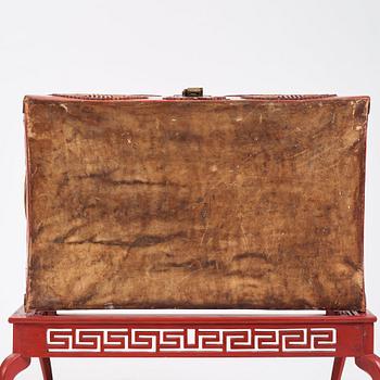 A red lacquered chest on a later stand, late Qing dynasty, 19th Century.