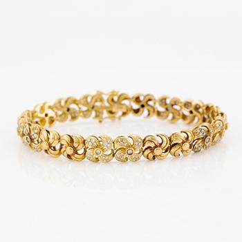 Armlänk, 18K guld med briljantslipade diamanter.