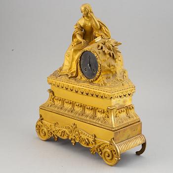 A French gilt bronze mantle clock, mid 19th century.