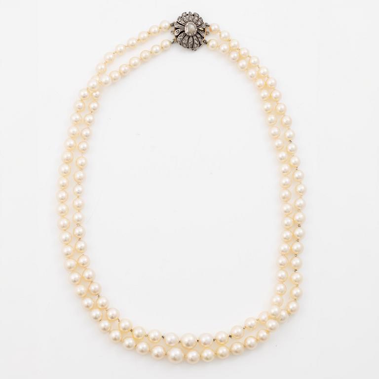 Two-row cultured pearl necklace with a silver and 18K gold clasp set with rose-cut diamonds.