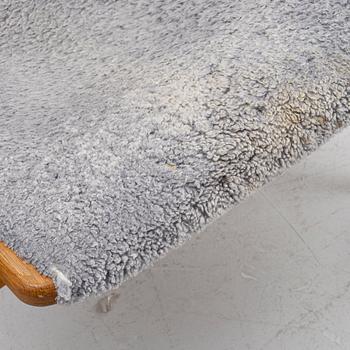 Yngve Ekström, a 'Lamino' armchair with ottoman and sidetable, Swedese, Sweden, 21st century.