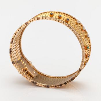 Armband, 18K guld, safirer, smaragd, diamanter ca 0.075 ct  tot. Importstämplat Koruteollisuus Tillander, 1962.