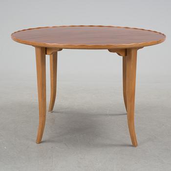 A mid 20th century coffee table in beech and veneered with mahogany.
