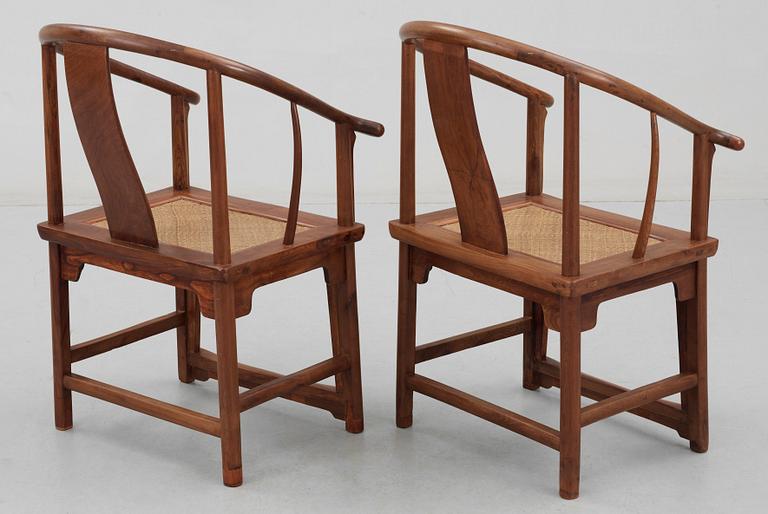 A pair of hardwood horseshoeback armchairs, Qing dynasty.