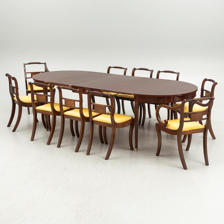 An Empire style dining table and ten chairs, second half of the 20th Century.