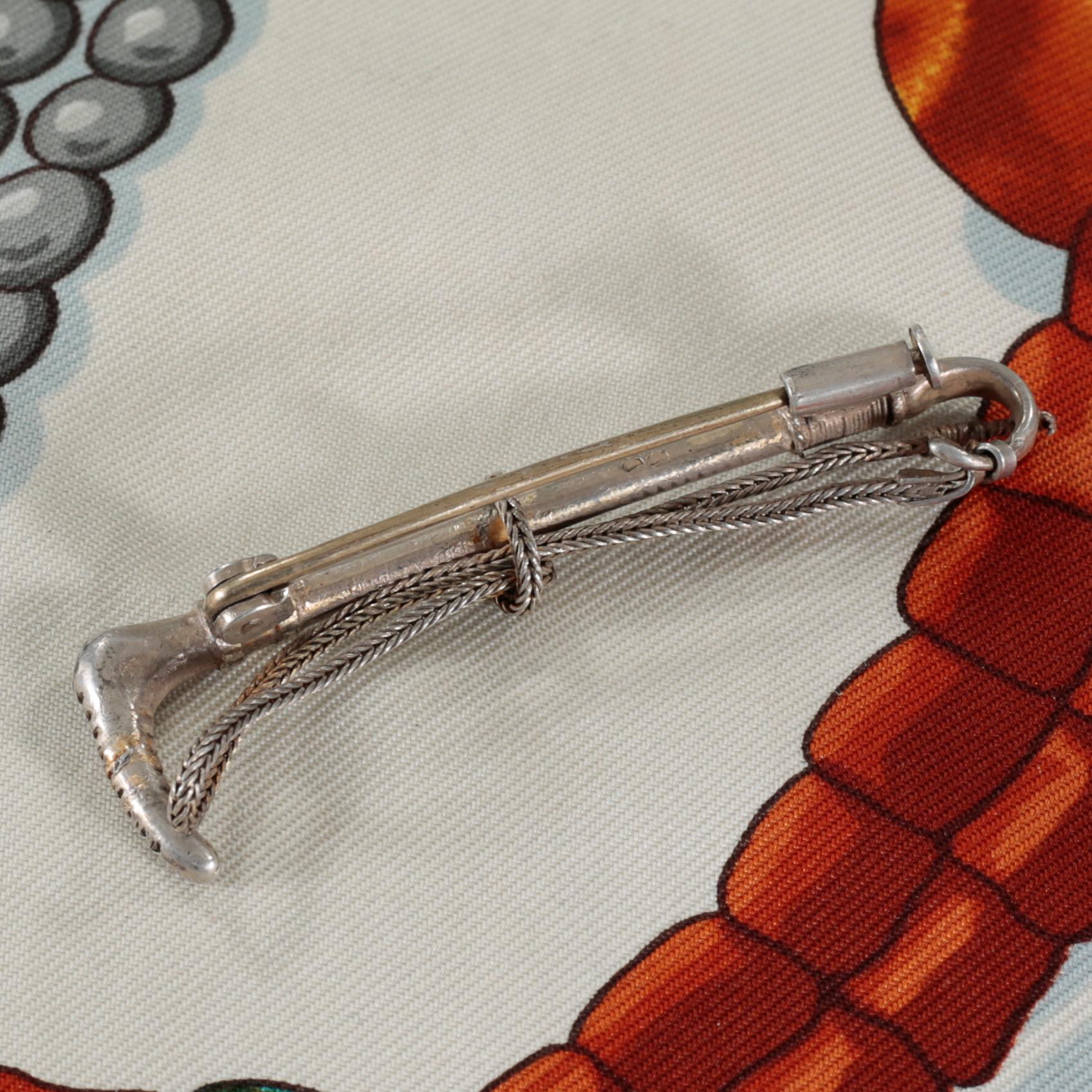 HERMÈS, "Tibet" scarf, and brooch.