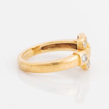 An 18K gold Cartier ring set with round brilliant-cut diamonds.