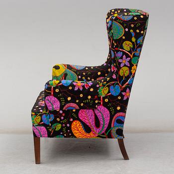 A 1960's/70's wing-chair with rosewwod legs.