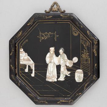 Four black-lacquered wall decorations, China, around 1900.