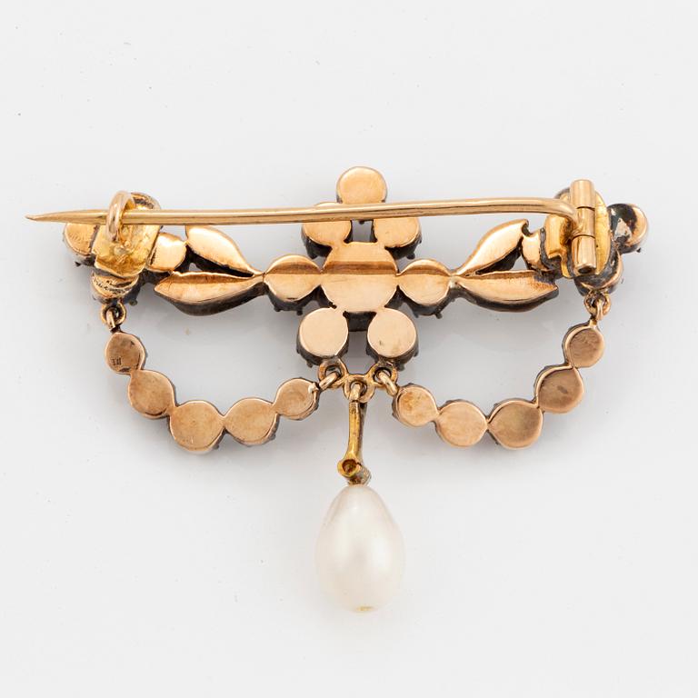 A silver and gold brooch with pearl and rose-cut diamonds.