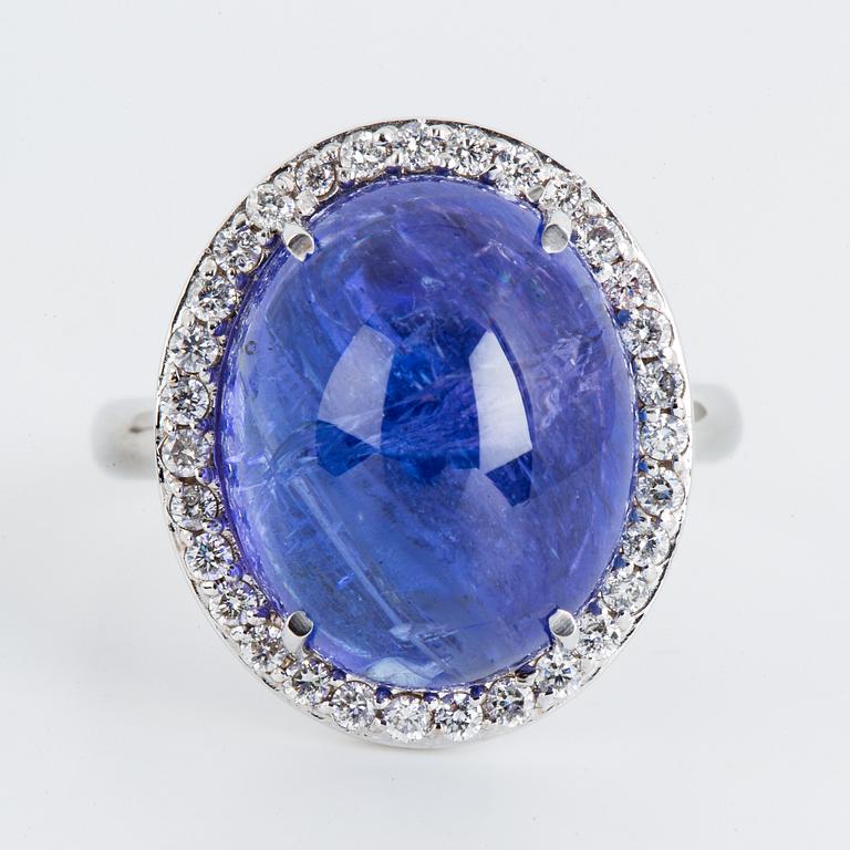 Cabochon-cut tanzanite and brilliant-cut diamond cocktail ring.