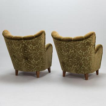 A pair of mid-20th-century armchairs.