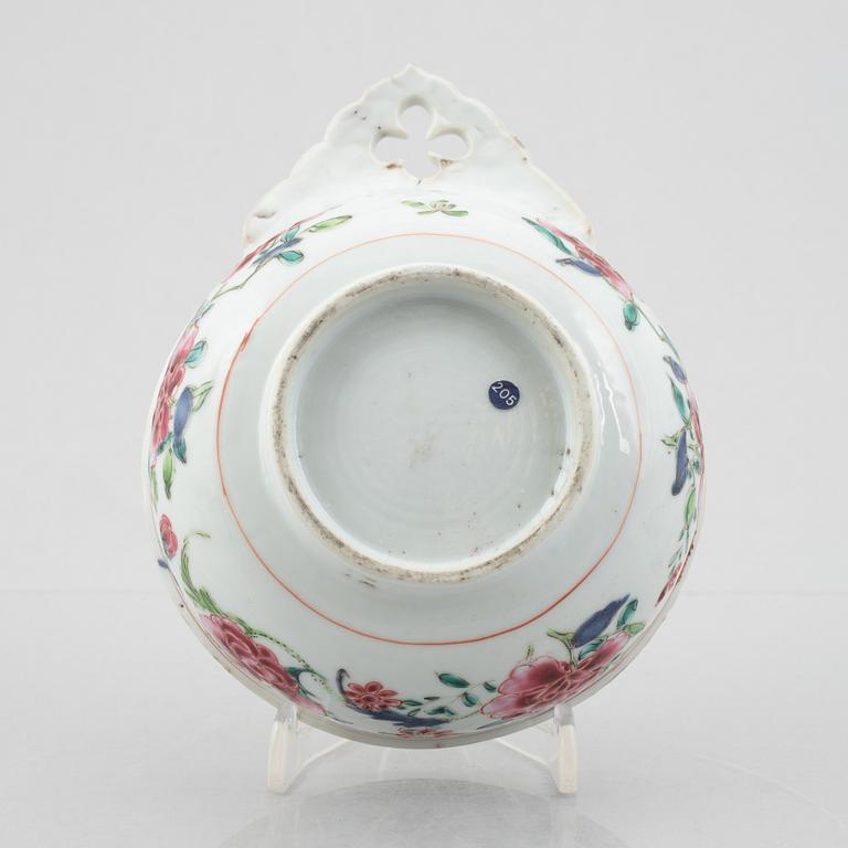 An export porcelain Famille Rose cup with handle and a blue and white sauce jug, China, Qing dynasty, 18th century.