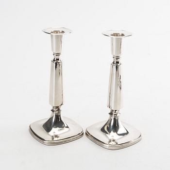 Two pairs of silver candle sticks from 1956 and 1992.