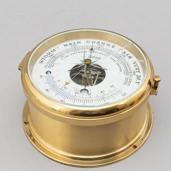 A BRASS MARINE CLOCK AND BAROMETER BY STOCKBURGER.
