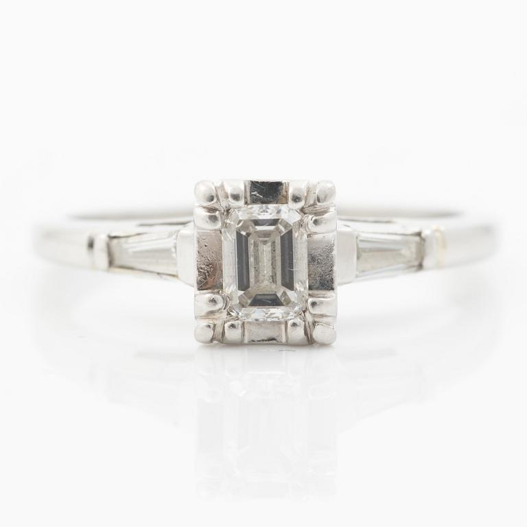 Platinum ring with an emerald-cut diamond and modified baguette-cut diamonds.