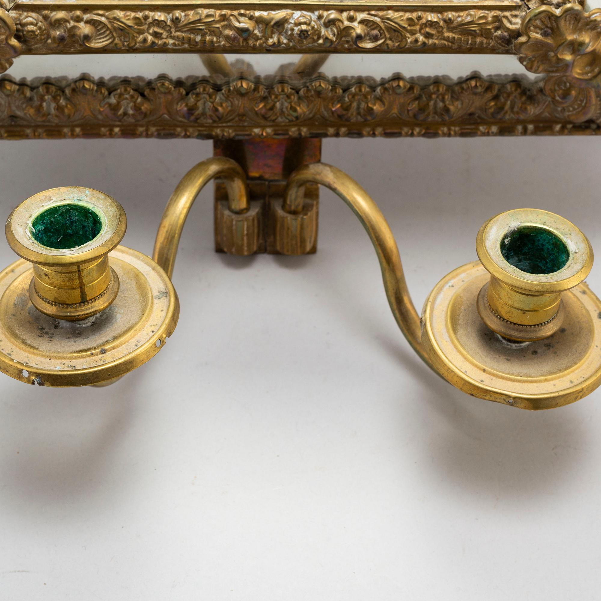 An early 20th Century pair of baroque style mirror sconses.