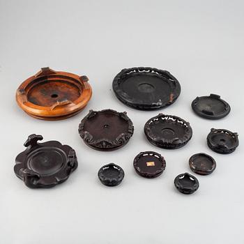 A group of Chinese 27 wooden and porcelain covers and stands, 19th/20th century.