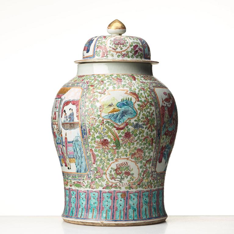 A Canton famille rose jar with cover on a tall wooden stand, Qing dynasty, late 19th Century.