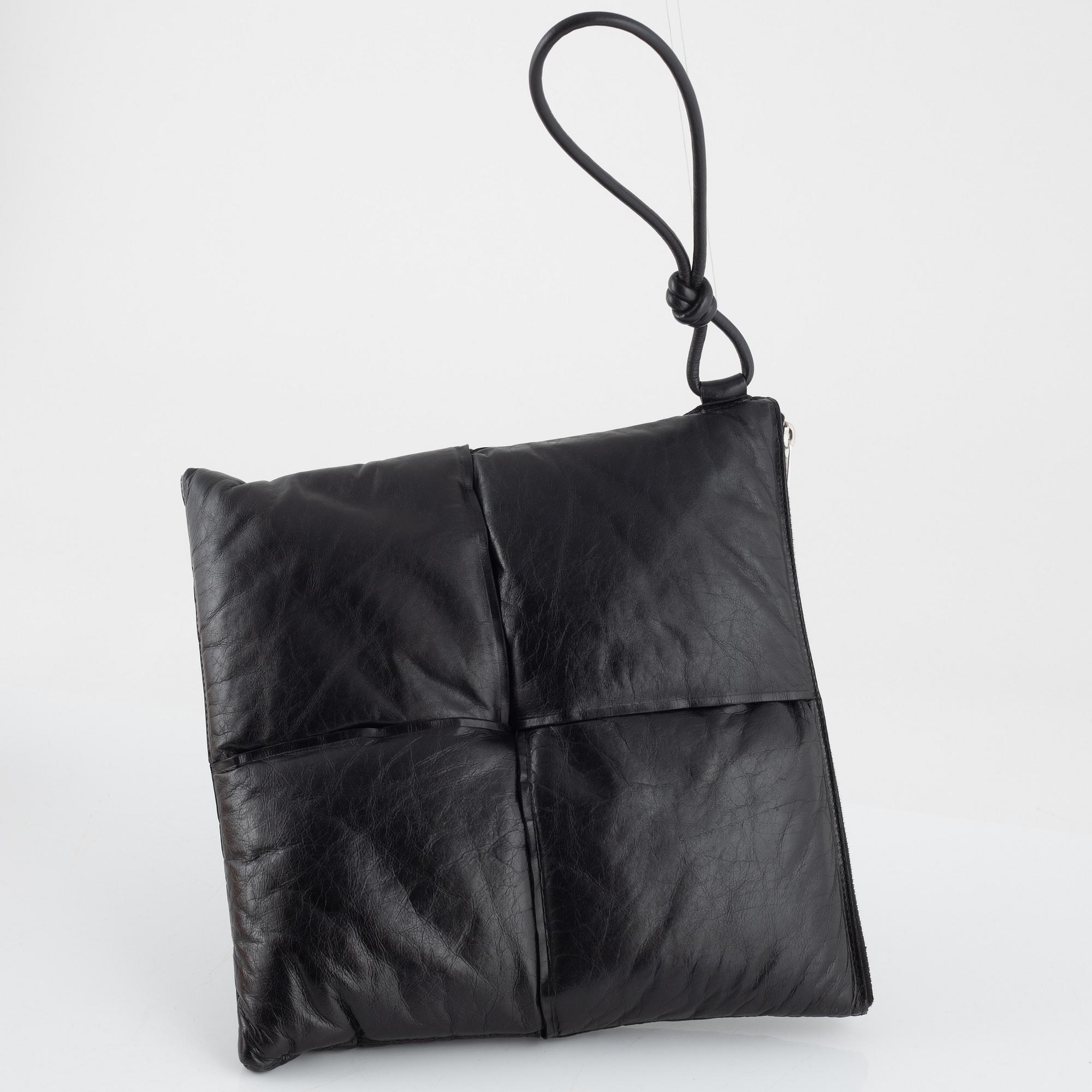 Bottega Veneta, a black leather handbag.