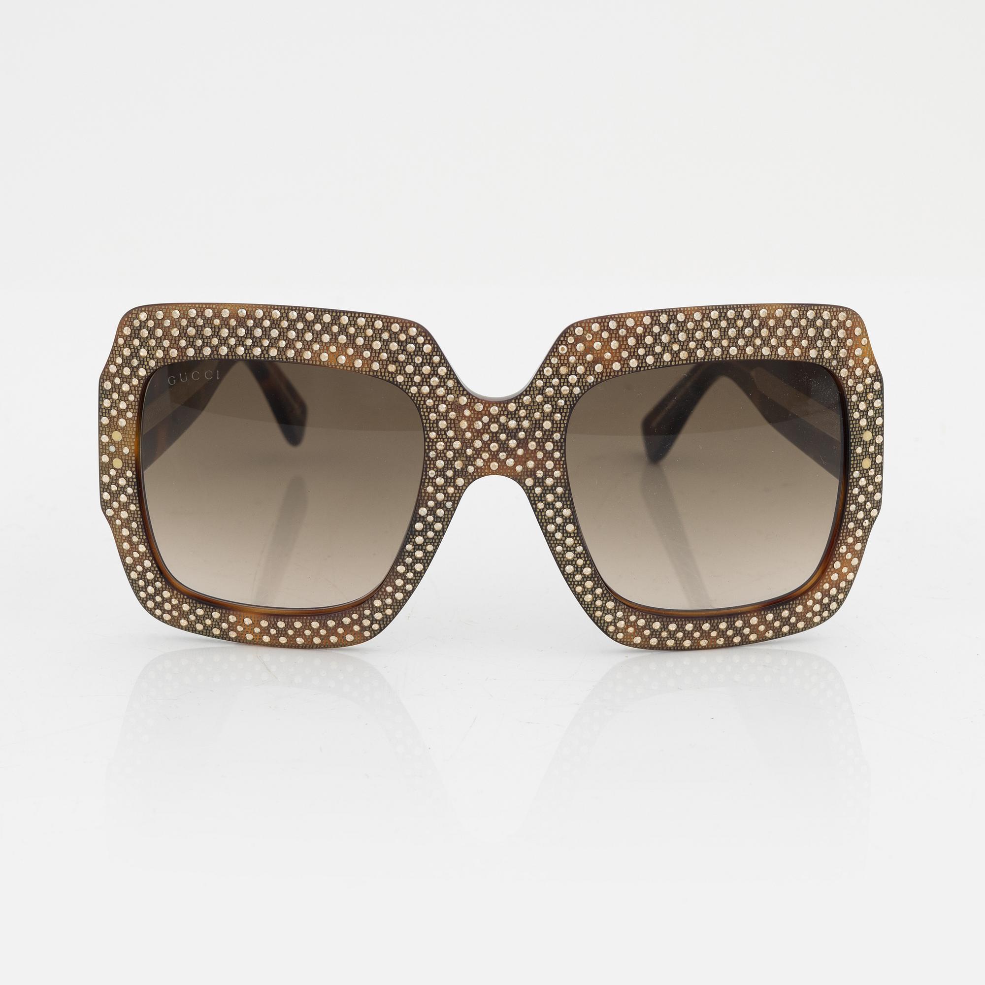 Gucci, a pair of black plastic and rhinestone sunglasses.