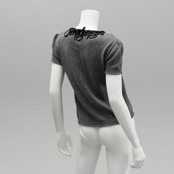 Cardigan and top by Moschino, Cheap and Chic.