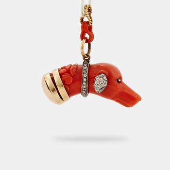 916. A 14 K gold and silver pendant with carved coral set with rose-cut diamonds.