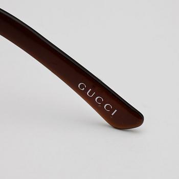 GUCCI, a pair of sunglasses.