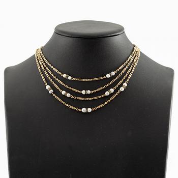 A W.A. Bolin necklace in 18K gold with pearls and white discs.