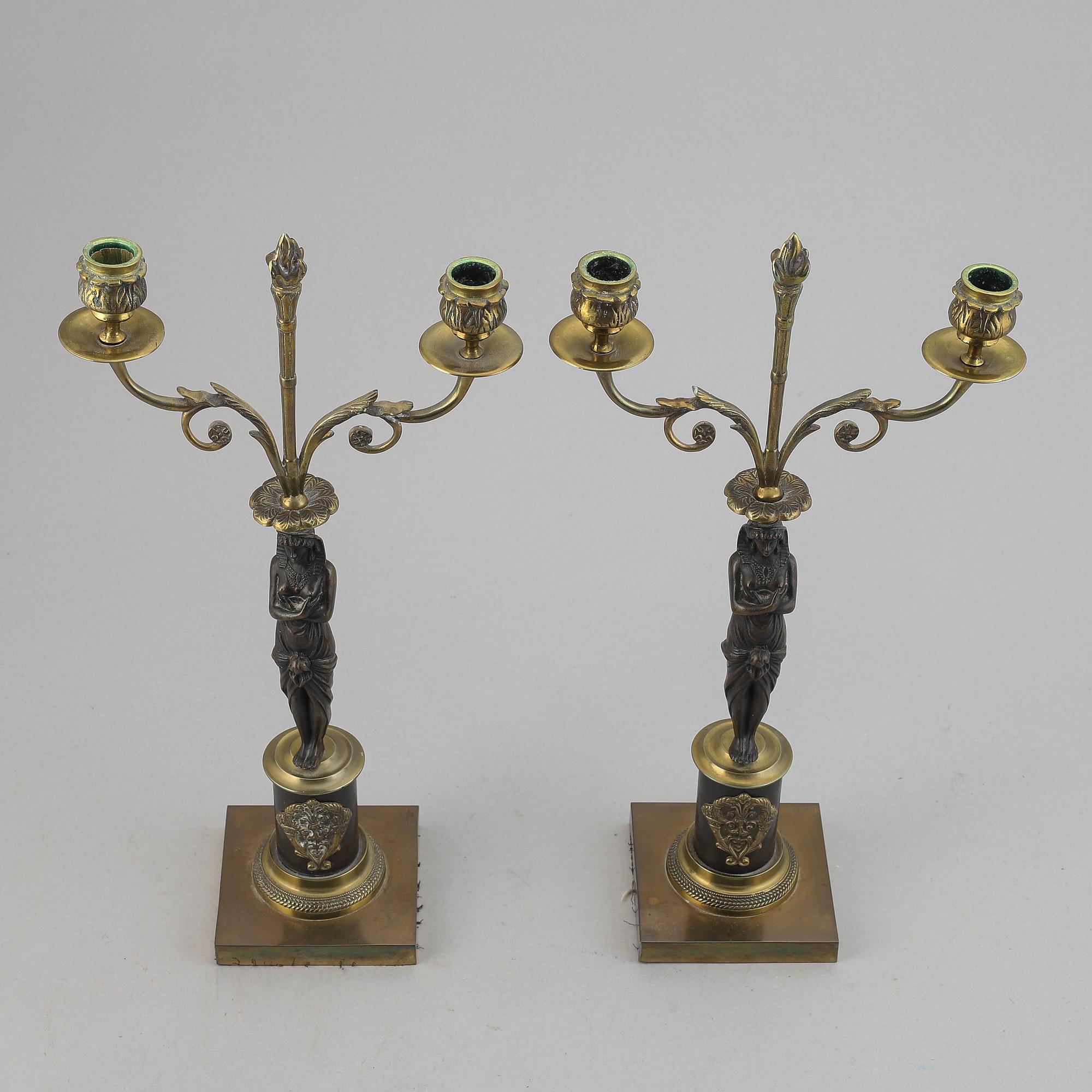 A pair of brass Empire style candle holders, 20th century.
