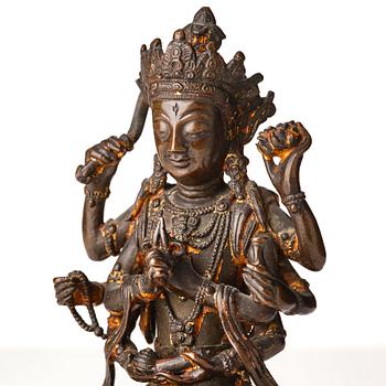 A cold gilt copper alloy figure of eight armed Boddhisattva Avalokiteshvara, late Ming dynasty.