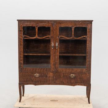 A 1920s  stained beech display cabinet.