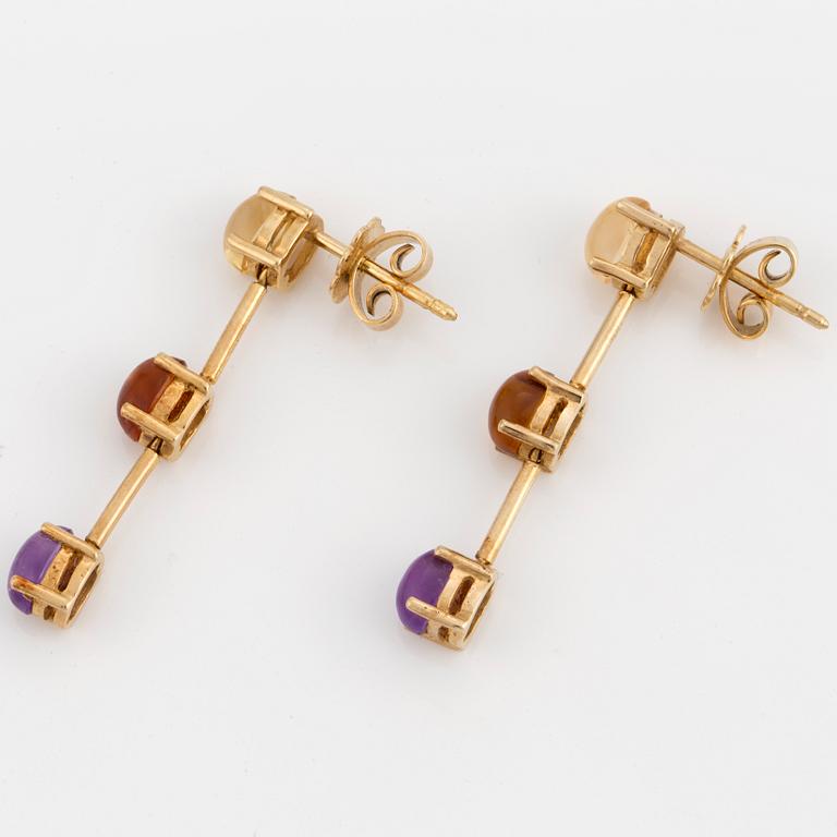 A pair of 18K gold earrings set with cabochon-cut citrines and amethysts.