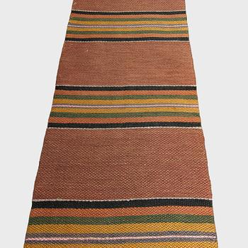 A 1930/1940s rag rug /runner. Circa 550 x 74 cm.
