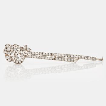 1022. A platinum brooch set with round brilliant- and eight-cut diamonds.