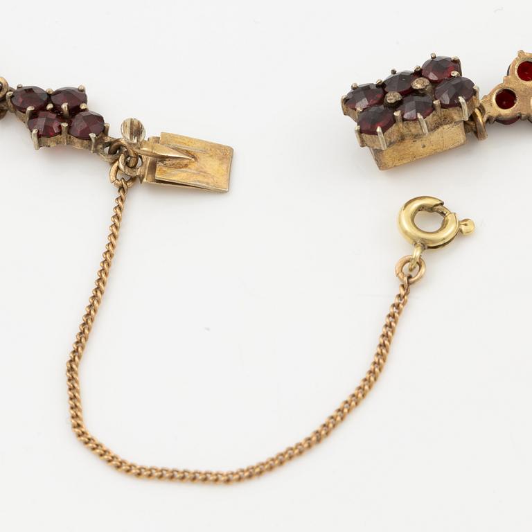 Garniture, two rings, brooch, two necklaces, and two pairs of earrings, armlet, garnets.