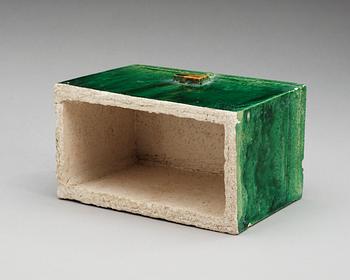 A green and yellow glazed potted figure of a chest, Ming dynasty (1368-1644).