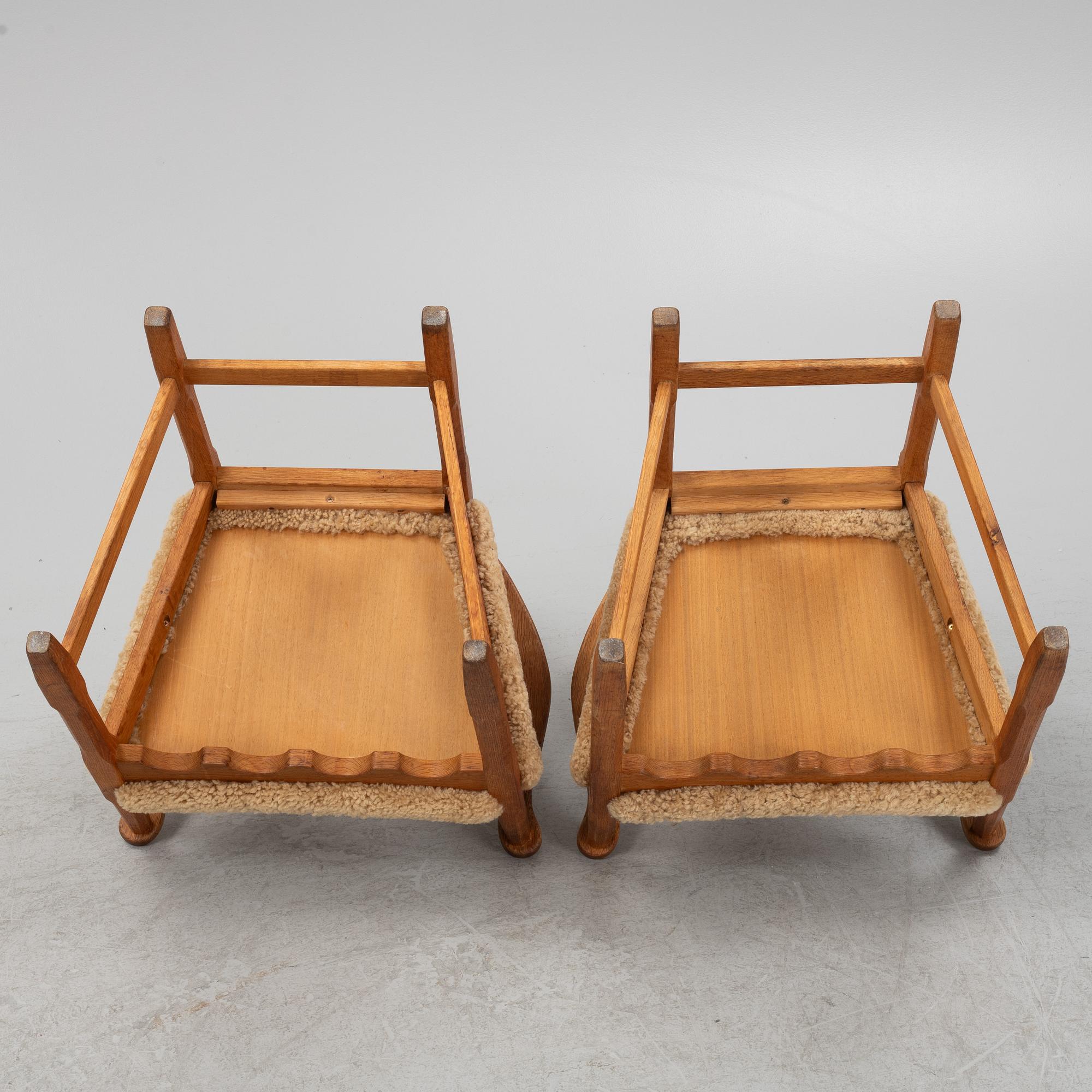 Henning Kjærnulf, a pair of oak 'Razorblade' armchairs with new sheepskin upholstery, from EGK, Demark, 1960s.