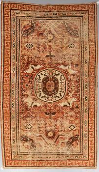 A CARPET, an antique Khotan, ca 296,5 x 181 cm.
