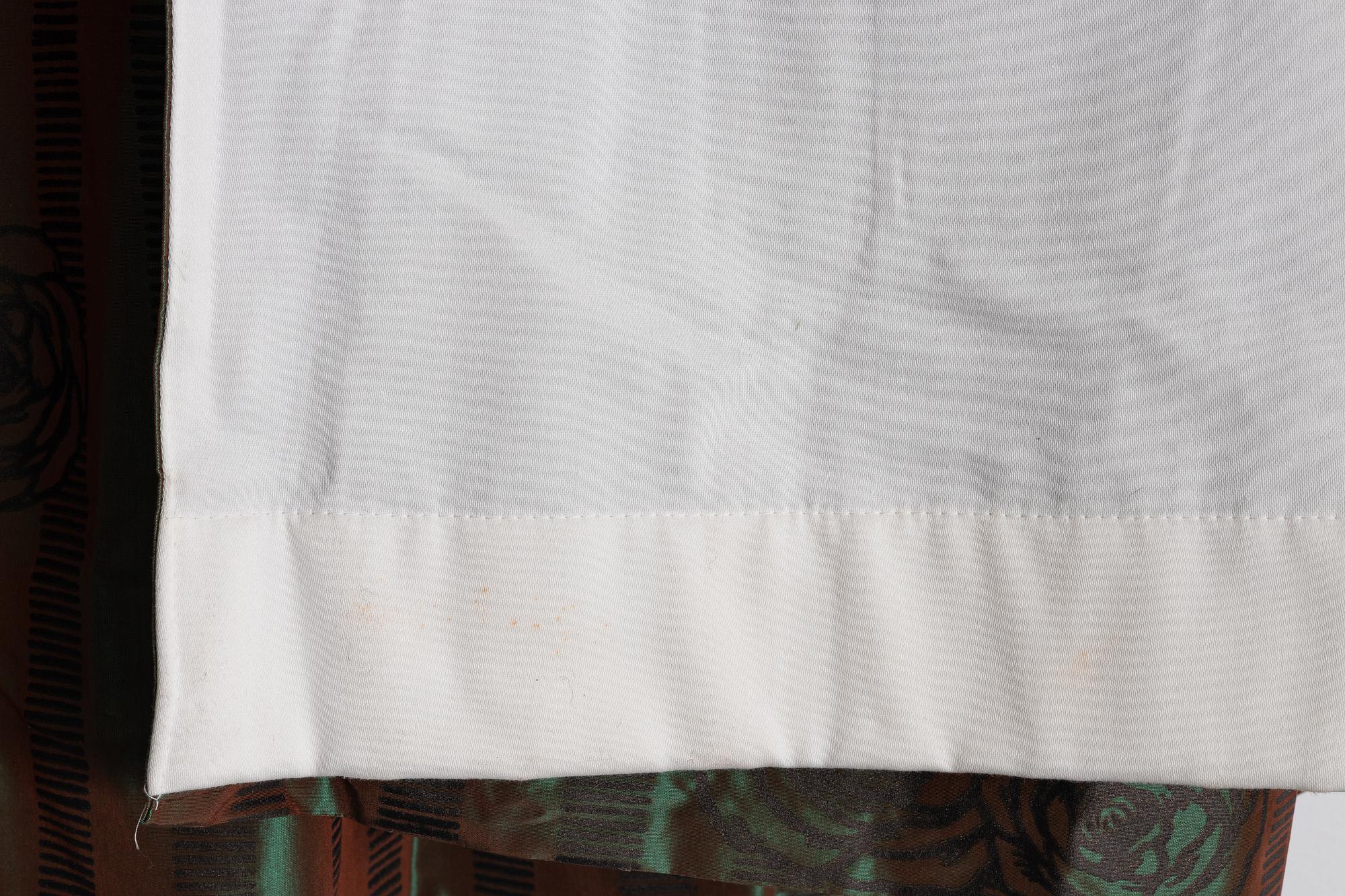 A set of four green silk curtains.