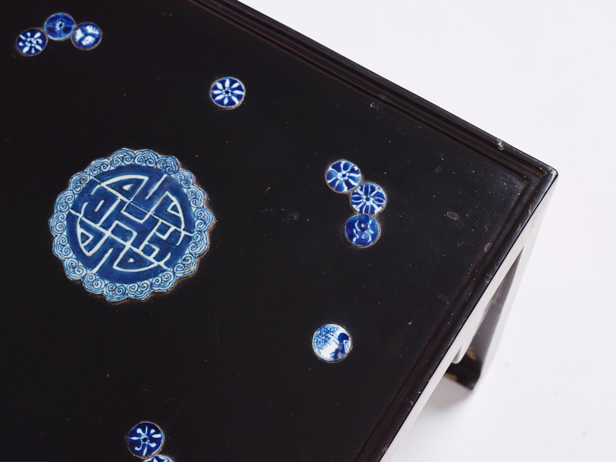 A Chinese black lacquered table with porcelain placques, presumably first half of the 20th century.
