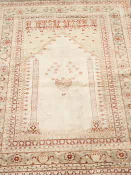 A RUG, an antique silk Tabriz, ca 165 x 118,5-111,5 cm.