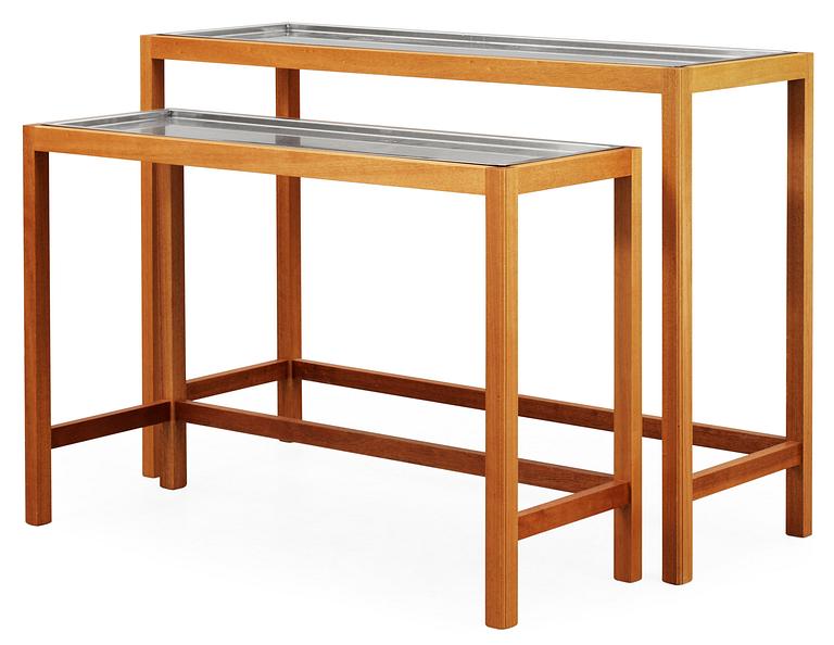 A Josef Frank set of mahogany and stainless steel tables by Svenskt Tenn.