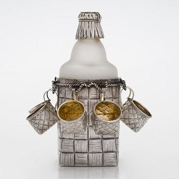A silver and glass bottle with eight silver charka, maker marks of Pyotr Yermolajevich Davidov, Saint Petersburg, 1884.