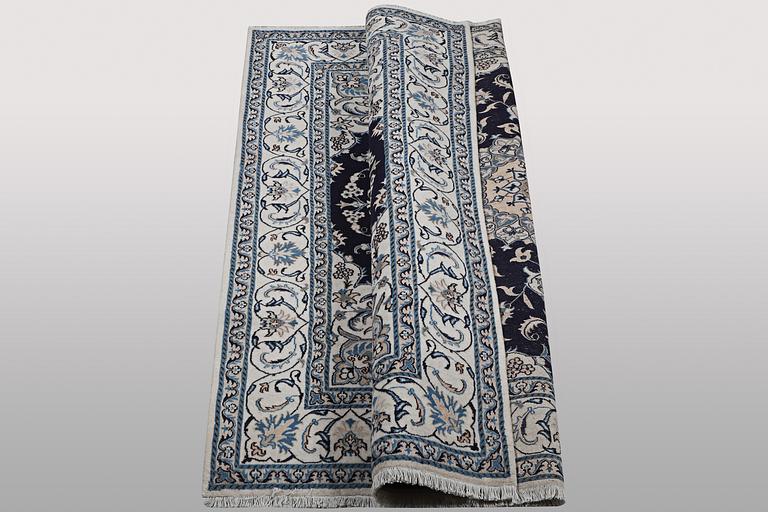 A carpet, Nain, part silk, ca 256 x 199 cm.