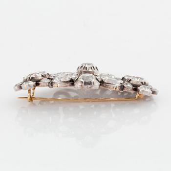 A gold and silver brooch set with old-cut diamonds.