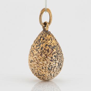 An egg pendant in silver with faceted paste.