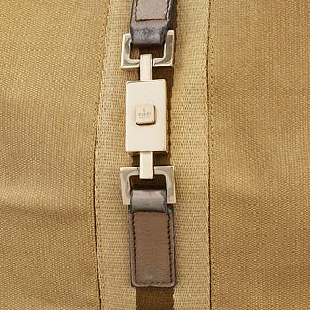 GUCCI, a metallic bag.